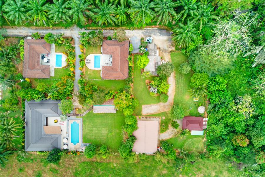 aerial view of three luxury private holiday pool villas in krabi thailand