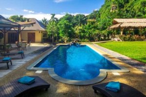 A large swimming pool of a pool villa in Krabi set in tropical gardens