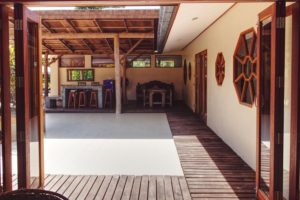 view from a villa across a tiled courtyard in sunshine