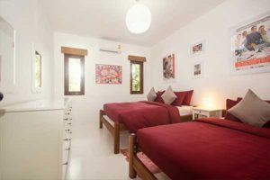 bedroom with twin beds decorated with movie posters