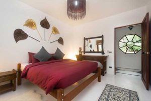 bedroom with queen sized bed and Thai style decoration