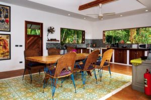 wooden dining table and open kitchen area in a holiday home