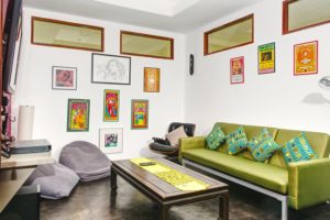 a colourful sofa in a decorated room set-up as a cinema room