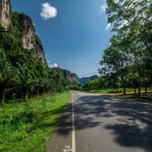 a straight road through country side of Krabi province